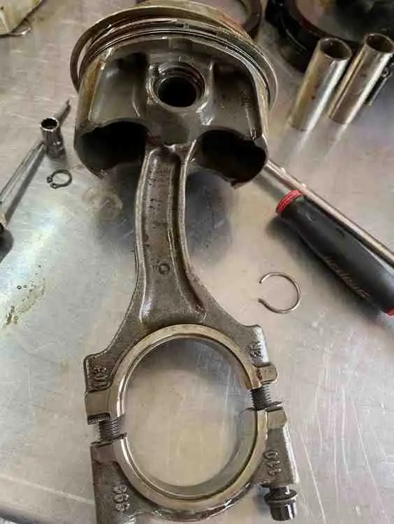 Failed Porsche piston and bent connecting rod due to hydrolock caused by faulty AOS system